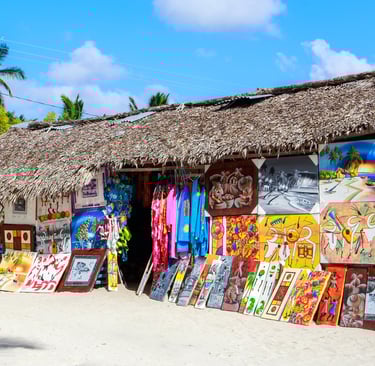 Colorful Dominican paintings displayed at a beach art and souvenir shop in the Dominican Republic