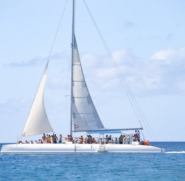 a sailboat with people on it in the ocean