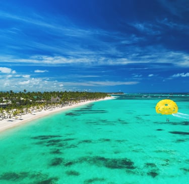 Aerial view over beach resort and ocean with Parasailing