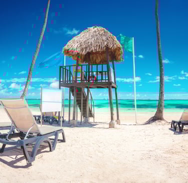 a beach with chairs and a life guard post in punta cana