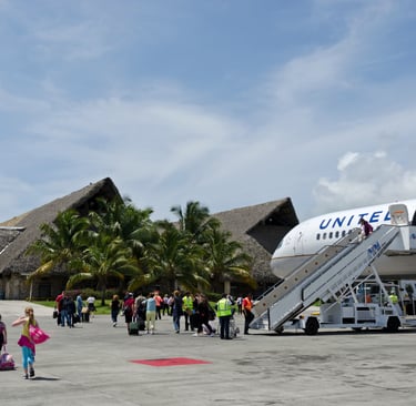Travelers arriving at Punta Cana Airport in the Dominican Republic from a United Airlines plane