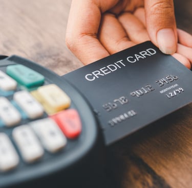 Person paying with credit card on card reader in the Dominican Republic, travel payment tips