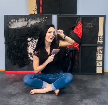 a woman sitting on the floor with brushes