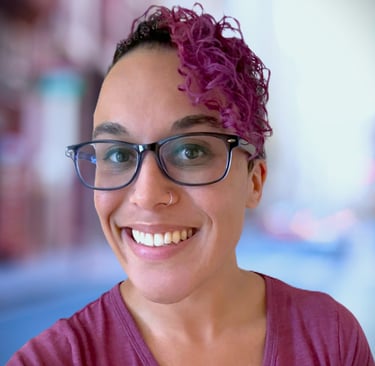 a woman with glasses and a purple shirt