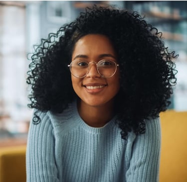 a woman with glasses and a blue sweater