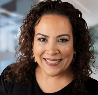 a woman with curly hair and a black shirt