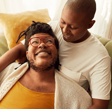 a man and woman sitting on a couch
