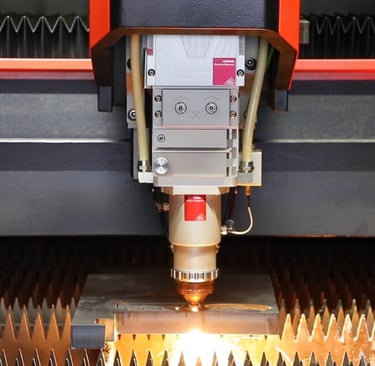 Industrial CNC fiber laser cutting machine precision processing a metal plate with sparks.