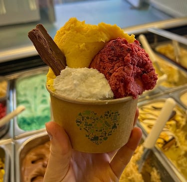 A pot with 3 scoops of ice crteam and a flake.