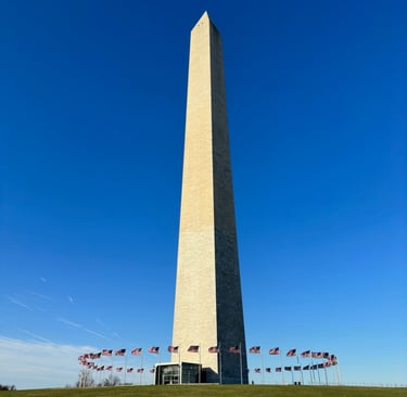 The Washington monument, an obelisk, in front of a blue sky