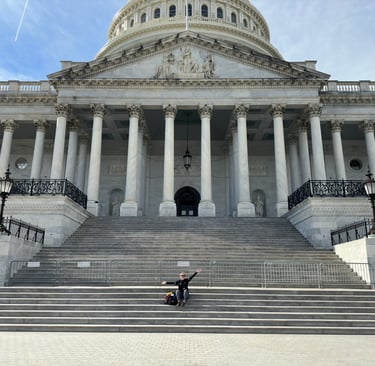 The United States capital building with a lady in front