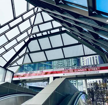 a train station with a sign that says, exit to Atlantic ave and exit to summer street