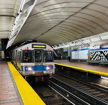 a MBTA blue line train pulling into a aquarium station