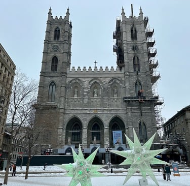 Basilique Notre-Dame de Montréal in the winter with large star statues in front of the towers