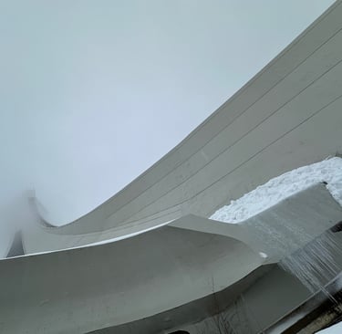 Montreal Tower covered with snow and poking into a cloud