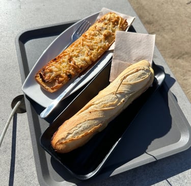 A flatbread and sandwich sitting next to each other on a plate