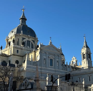 Almudena Cathedral at sunset, a Gothic cathedral with a blue sky behind