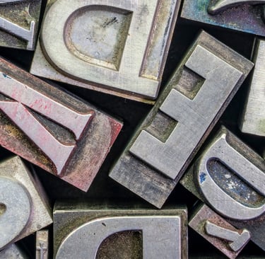 a bunch of old metal letters with different styles of letters