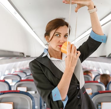 Flight attendant demonstrating how to secure an oxygen mask, symbolizing self-care.
