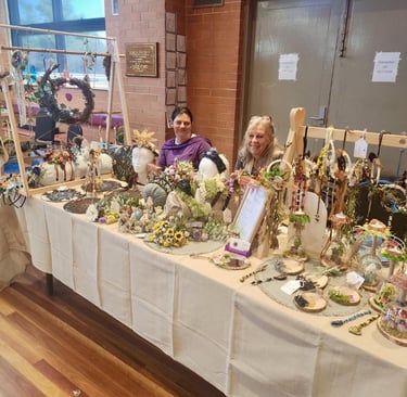 a market stall table selling handmade headwear, suncatchers & spiritual products