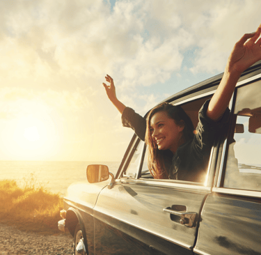A happy female riding in a car after learning what to expect from counselling.