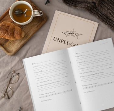 Open journal & tea on a neutral surface, representing a quiet pause for parental self-reflection