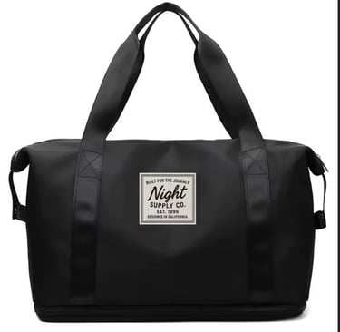 Black duffel bag with dual handles and front Night Supply Co. logo patch, designed in California.