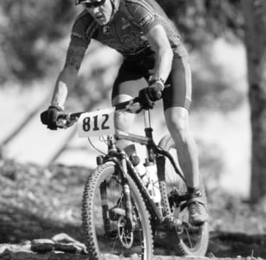 Carl Gregory  is in a mountain bike race. Black and white picture