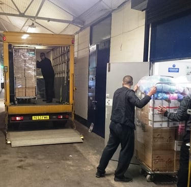 Man and Van hired by shopkeeper loading from their warehouse
