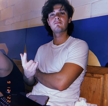 Image of Kevin Bockius, Mechanical Engineer, smiling for picture while working on laptop