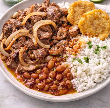 Puerto Rican bistec encebollado steak with onions served with white rice, stewed red beans, and tost