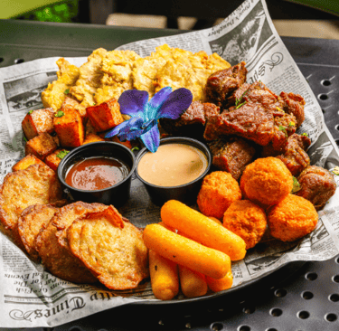 a plate of puerto rican fried street food with a flower in the center