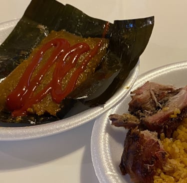 a plate of puerto rican pasteles pernil and arroz con gandules