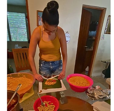 a woman making puerto rican pasteles