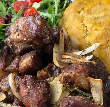 A plate of puerto rican food carne frita con mofongo