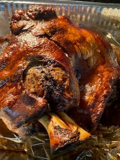 Puerto Rican pernil asado roast pork with crispy edges served with pigeon peas rice