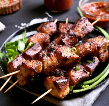 a plate of puerto rican pinchos meat and vegetables on a table