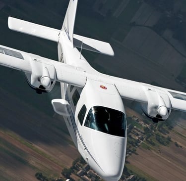 a white airplane flying over a field