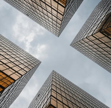 a group of tall buildings with a sky view of the sky