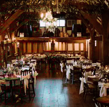 a large room at the Moat in Wrotham with tables and chairs and a chandelier