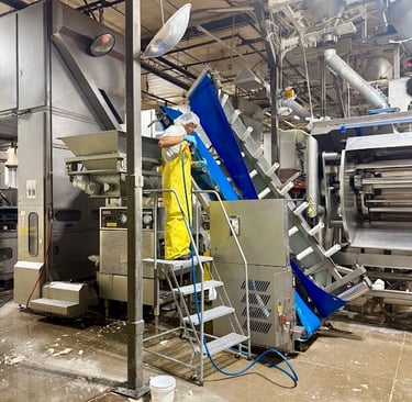 PRECISION CLEANING SERVICES SPECIALIST SANITIZES A HOPPER PER GMP REQUIREMENTS