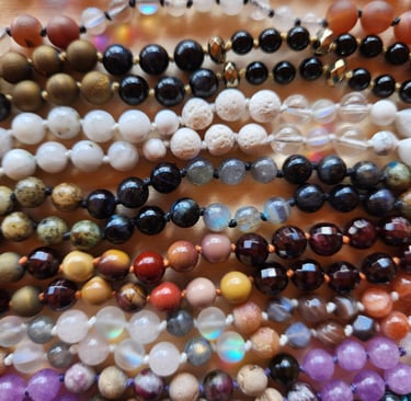 Hand-knotted gemstone mala necklace with 108 beads, created by Tina Medina for spiritual meditation and energy healing