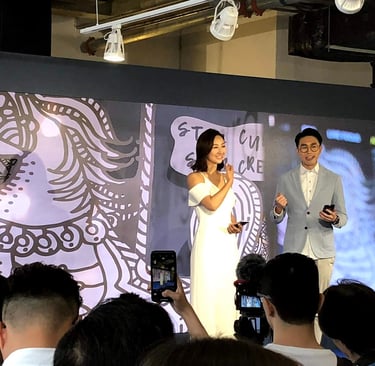 a man and woman standing on a stage