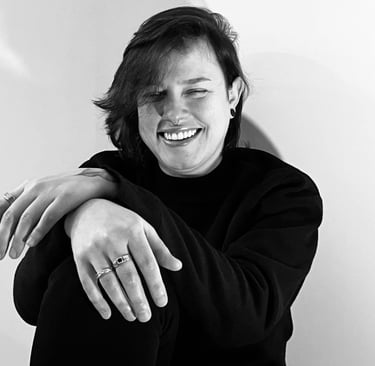 A woman with a smile, the image is black and white.