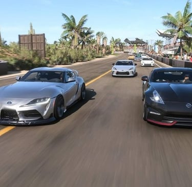 a group of four sports cars driving down a road