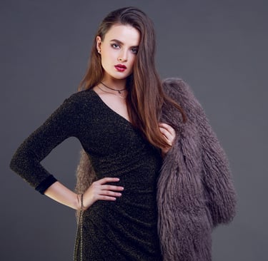 model wearing black dress with fur coat
