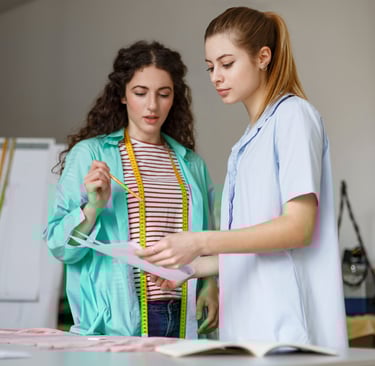 Designers-discussing-fashion-trends-with-fashion-illustration-in-hand