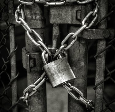 a gray lock on a steel fence