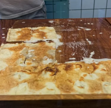 Close-up of freshly baked Focaccia di Recco with melted cheese oozing out
