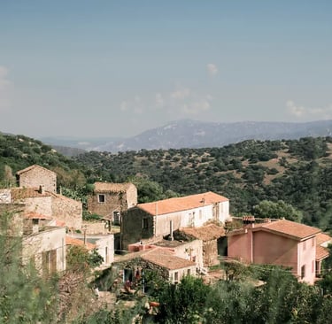 a mountaintop with a view of a village's Lollove in Sardinia